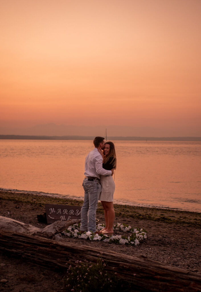 Couple during surprise proposal at beach in WA