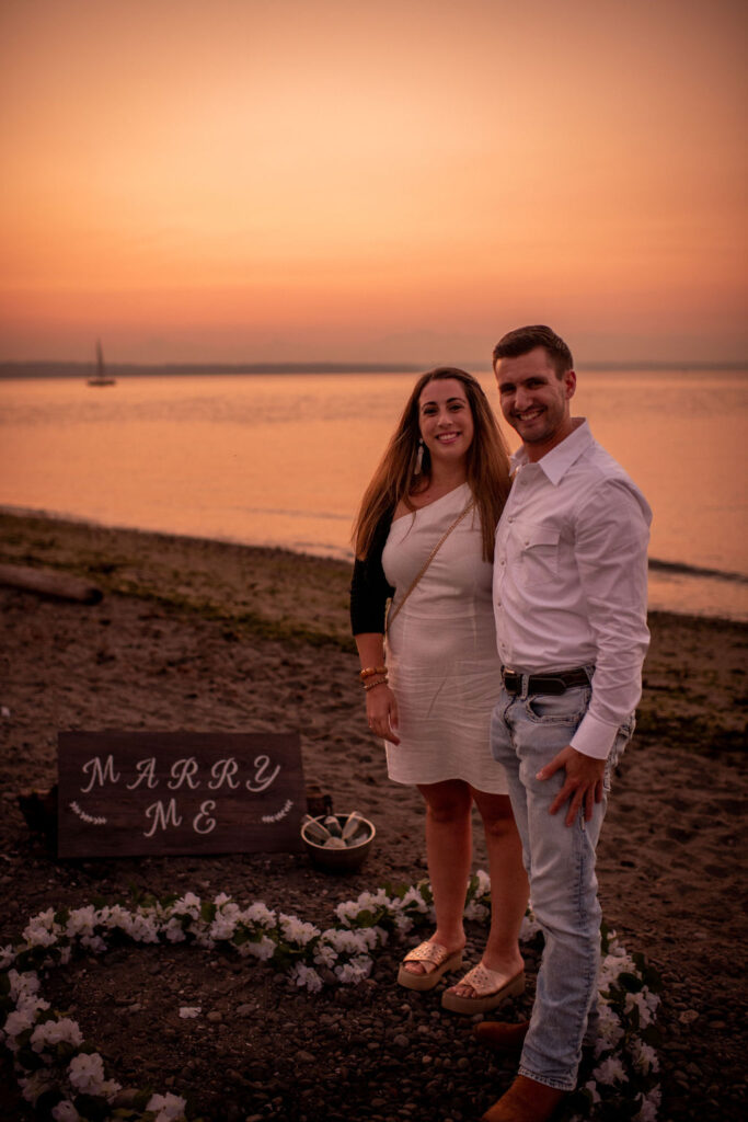 Couple after surprise beach proposal at Golden Garden Parks in Seattle Washington