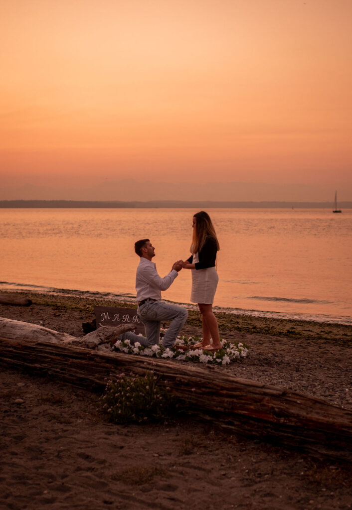 Couple during surprise proposal at Golden Garden Parks in Seattle Washington