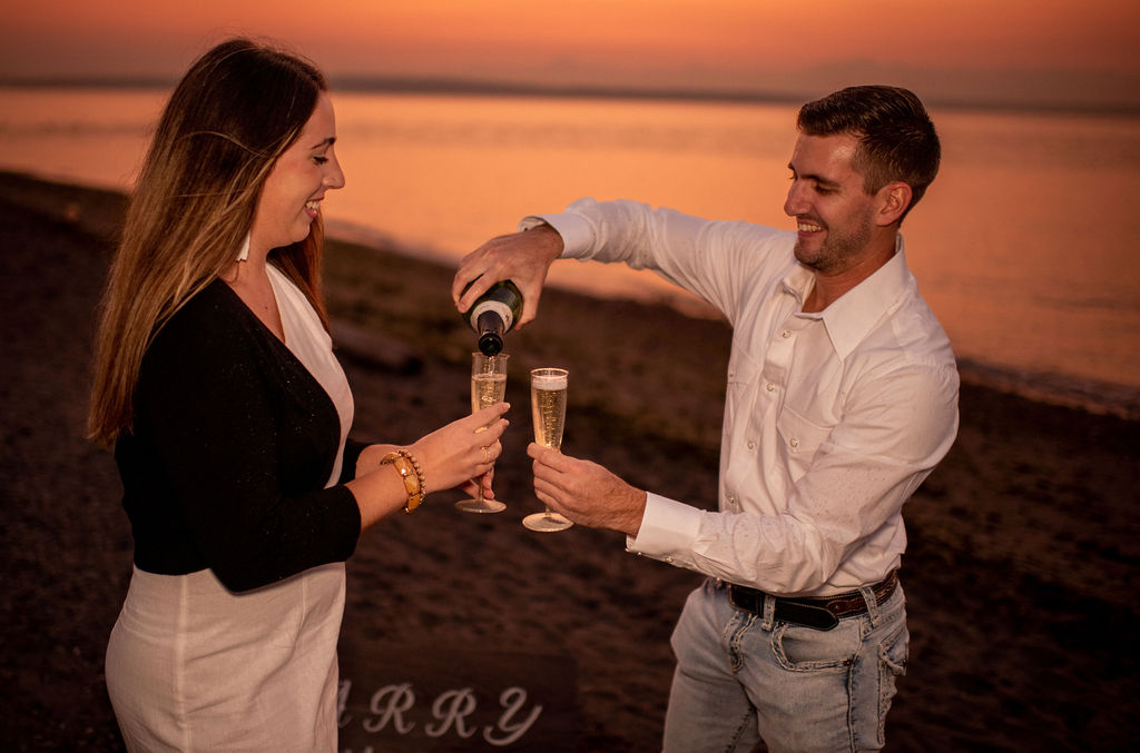 Couple pouring champagne after surprise proposal in Seattle