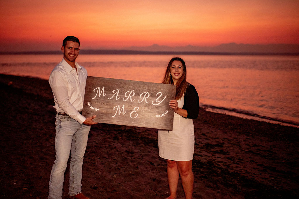 Couple after surprise beach proposal at Golden Garden Parks in Seattle Washington