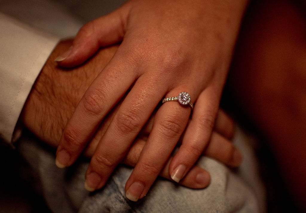 Close up of hands and engagement rings