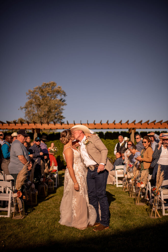 Bride and groom kissing after ceremony