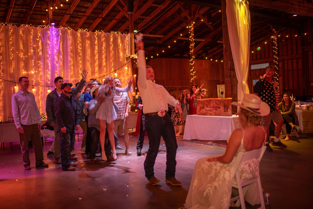 bride and groom playing garter toss
