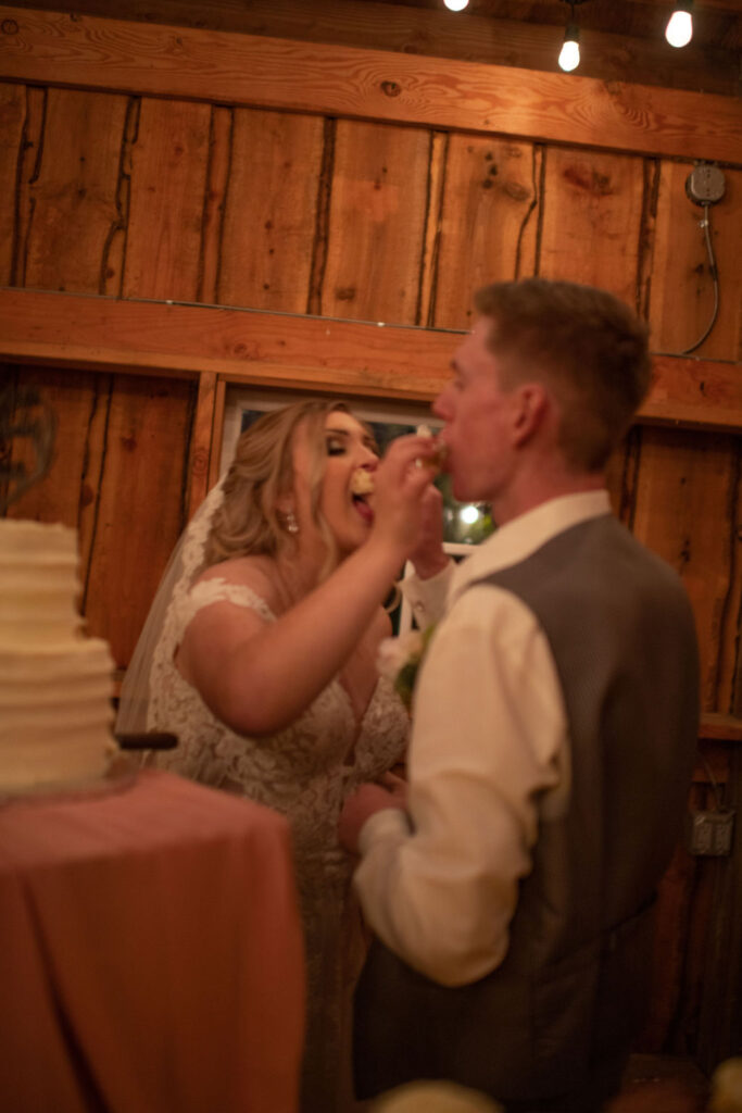 Bride and groom feeding eachother cake