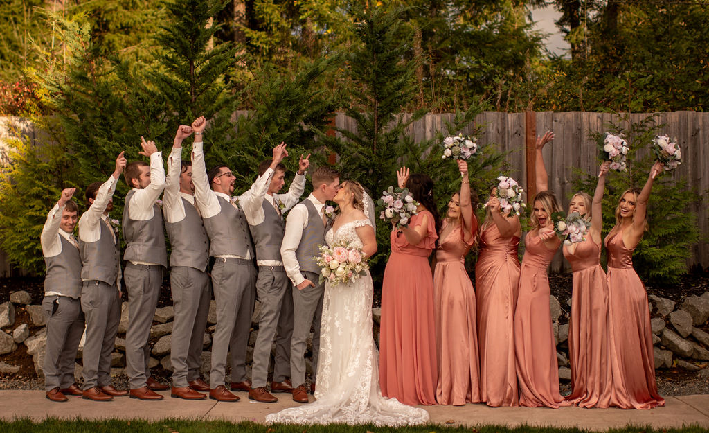 Bride and groom posing with bridal party 
