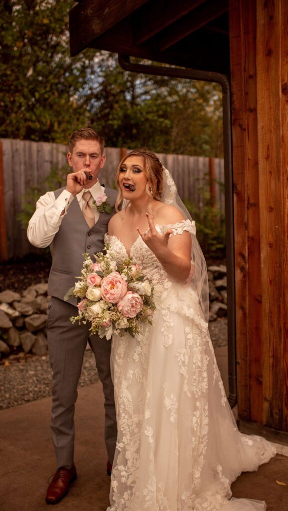 Bride and groom smoking cigars on wedding day