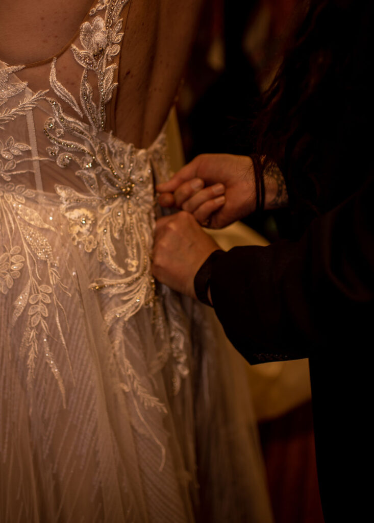Bride getting dress zipped up