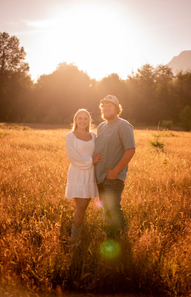 Couple posing for golden hour engagement photos in the fields of Washington