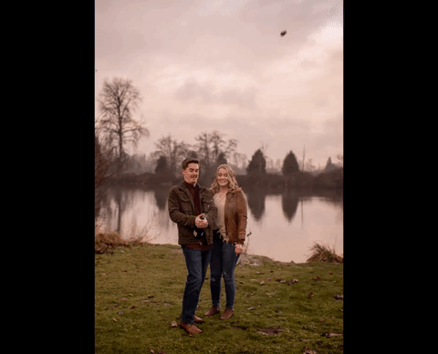 Couple popping champagne during engagement session