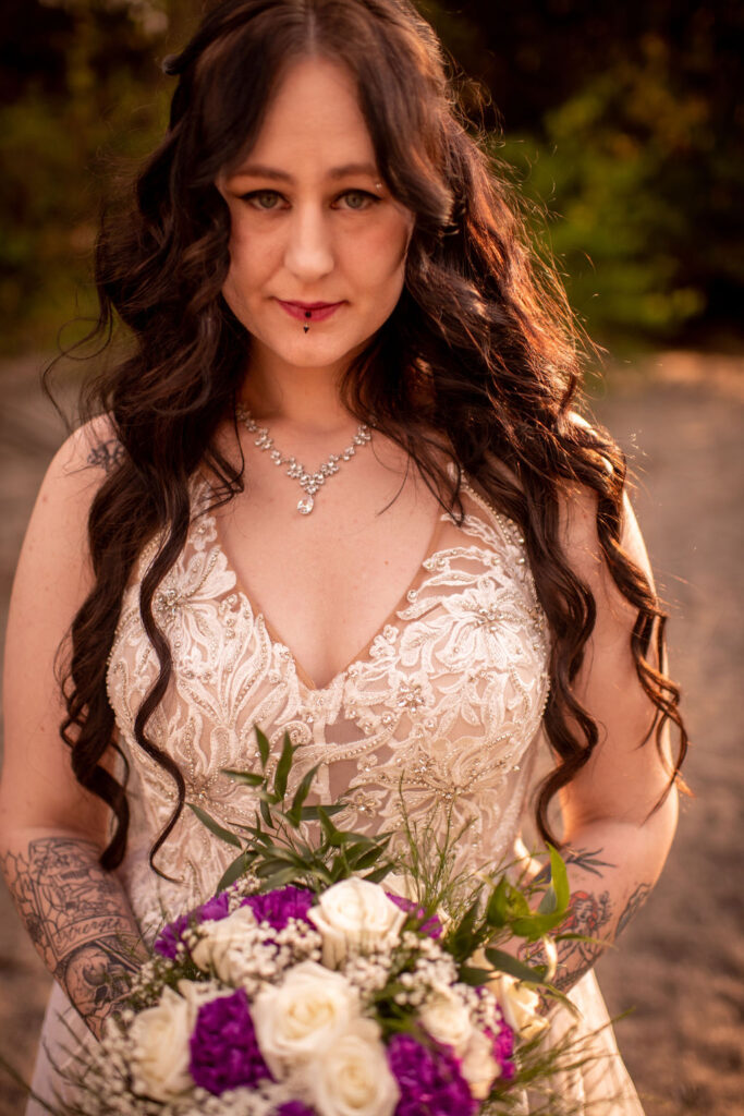 Bride holding purple and white wedding bouquet