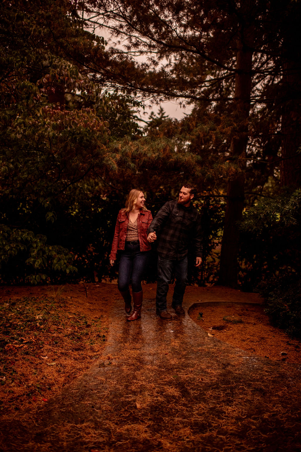 amazing couple holding hands during their fall engagement photoshoot at evergreen arboretum