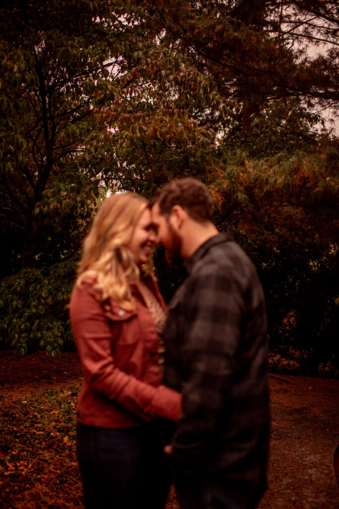 beautiful couple looking at each other at their fall photoshoot