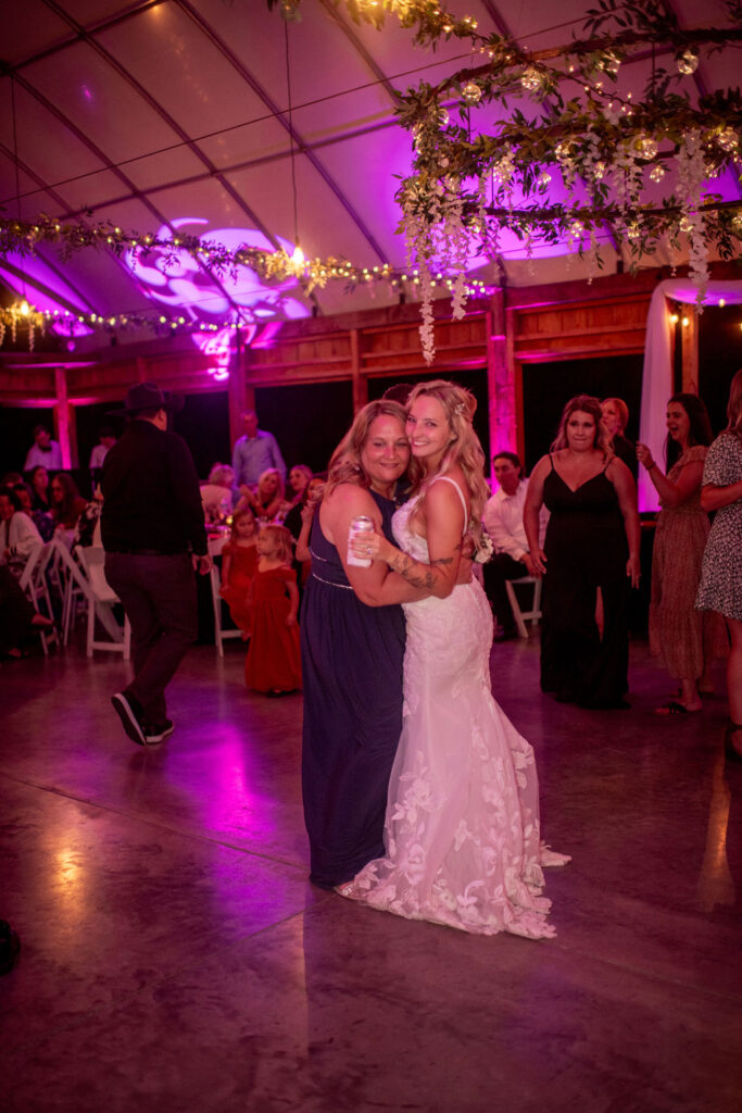 Beautiful bride hugging a family member after her ceremony at the dance floor