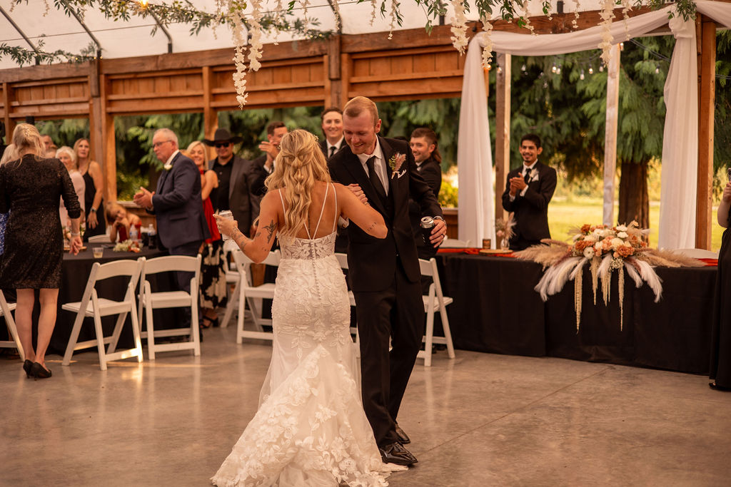 Beautiful bride and groom dancing after their ceremony their fall wedding