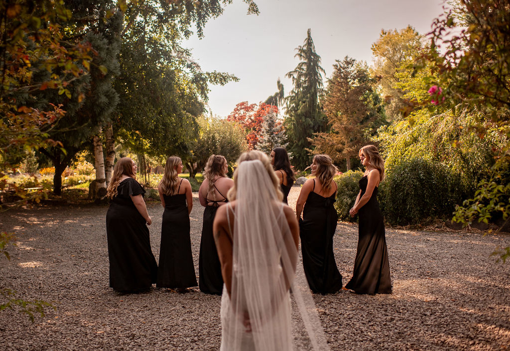 Bride behind her bridesmaids before their first look at her fall wedding