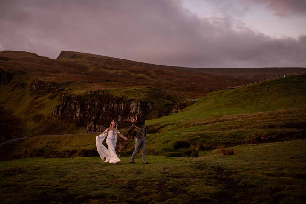 couple walking at quiraing in scotland heights during their adventurous elopement 
