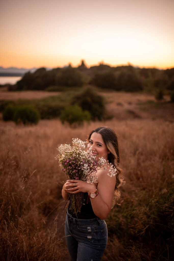 birthday girl holding flowers near her face during her photoshoot