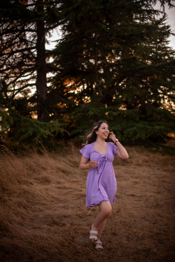 girl during her birthday session wearing a purple dress